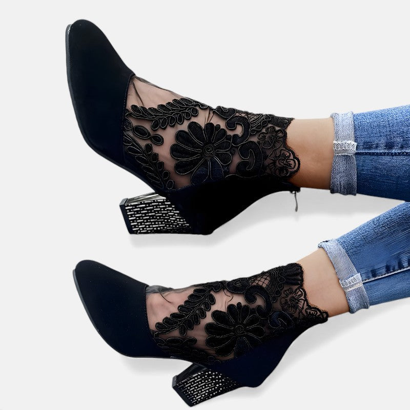 A woman wearing wide-toe orthopaedic heels, standing comfortably in an elegant everyday look.