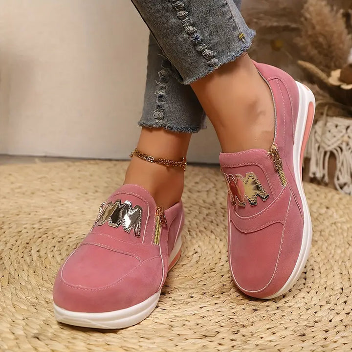 A woman wearing cushioned side-zip trainers with a relaxed everyday outfit
