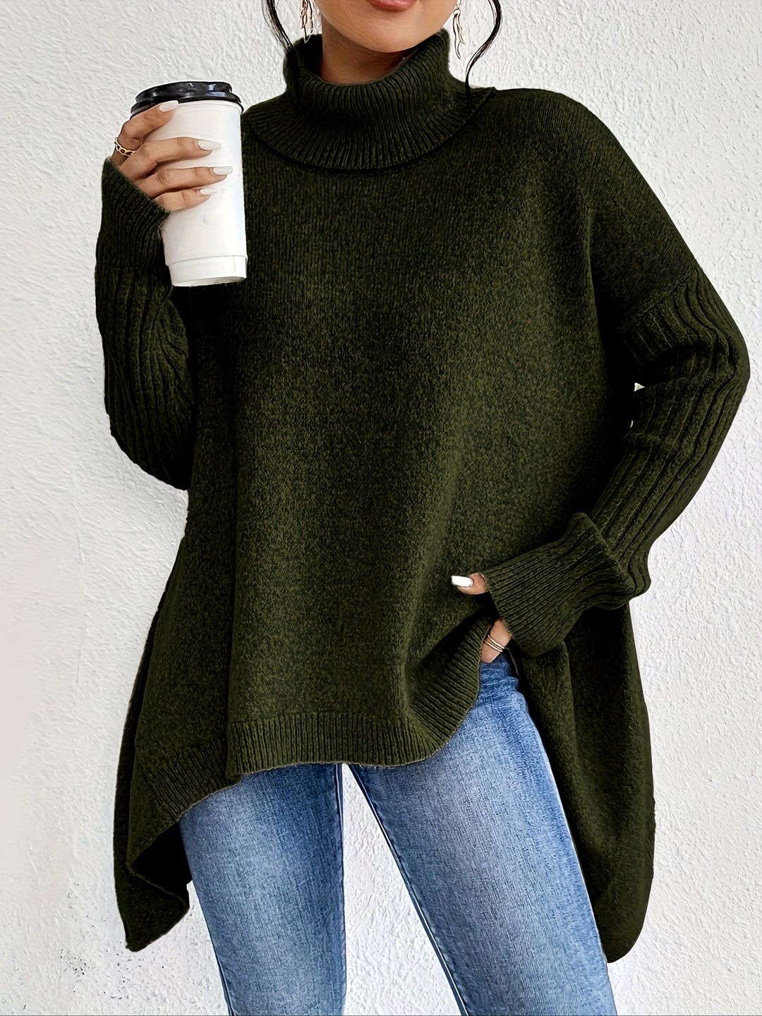 A woman wearing a stand-collar jumper with a chic asymmetric drape, warm and polished.