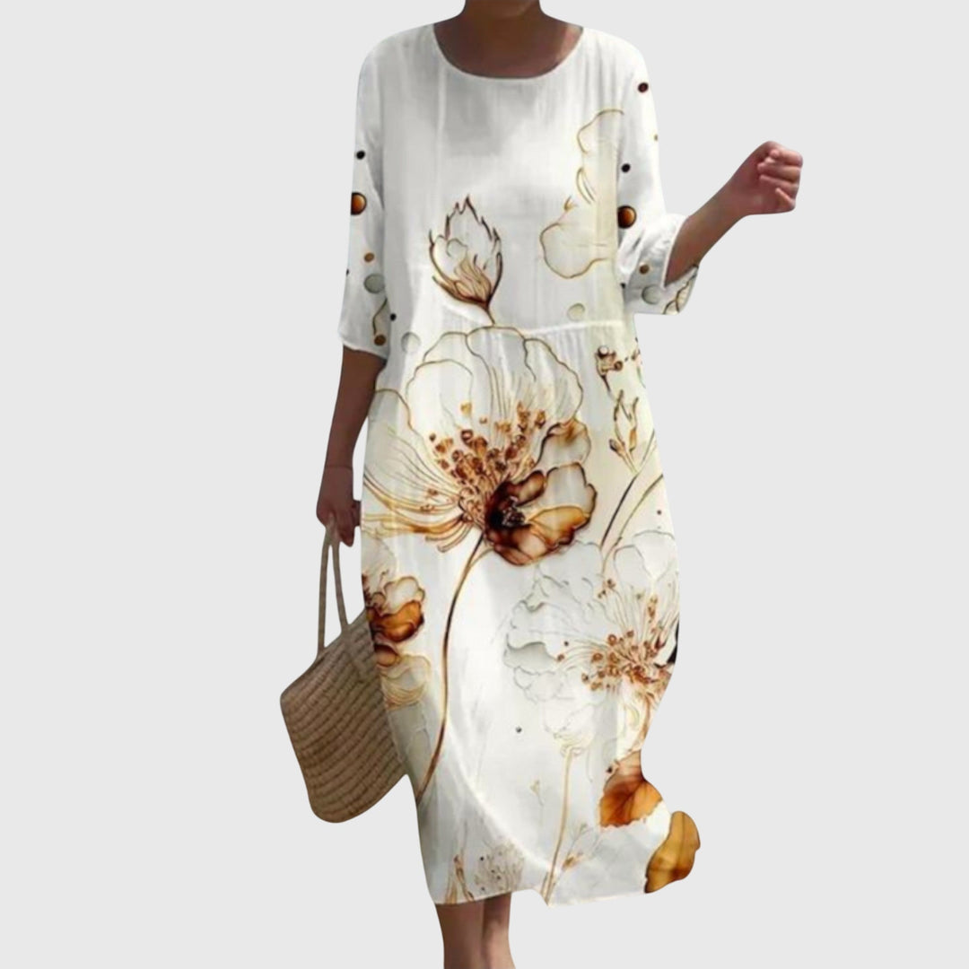 Woman wearing a long flowing maxi dress with a delicate floral print, moving gracefully.