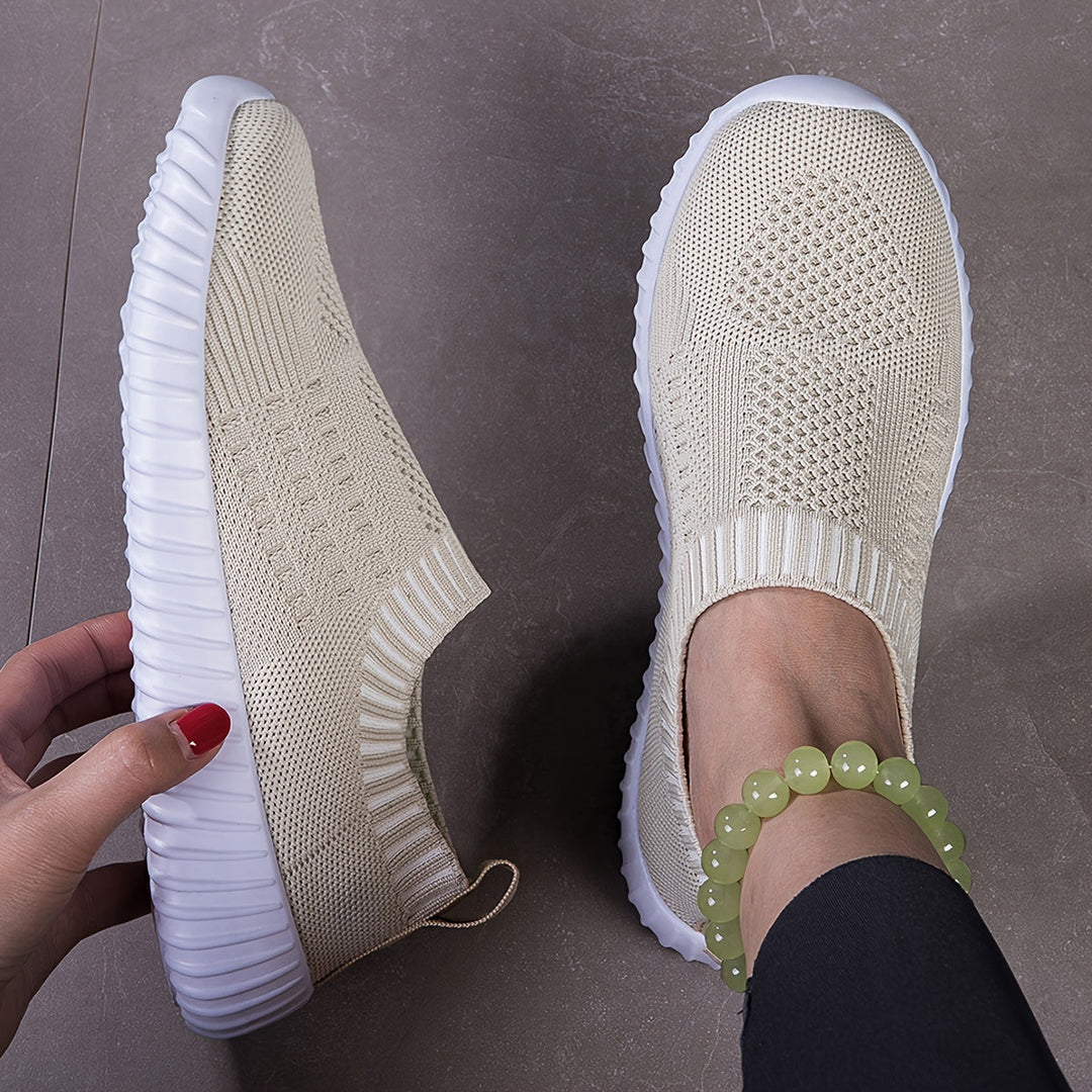 A woman slipping on ultralight sock-style trainers that hug the foot.