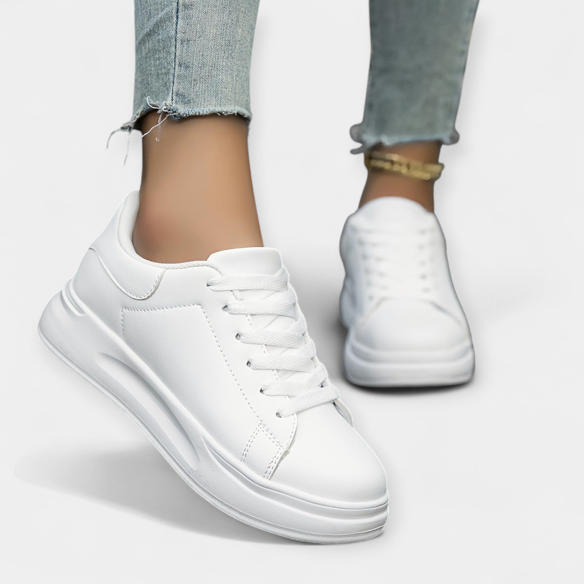 Women's classic white trainers with a clean minimal design and cushioned support sole