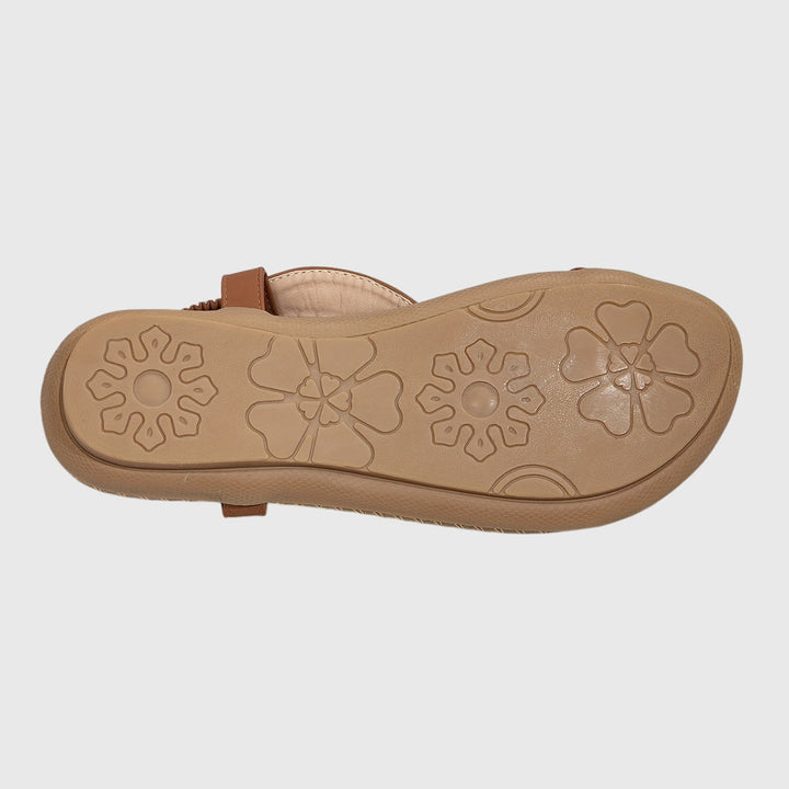 A woman standing comfortably in wide-fit cushioned support sandals with open-toe straps.