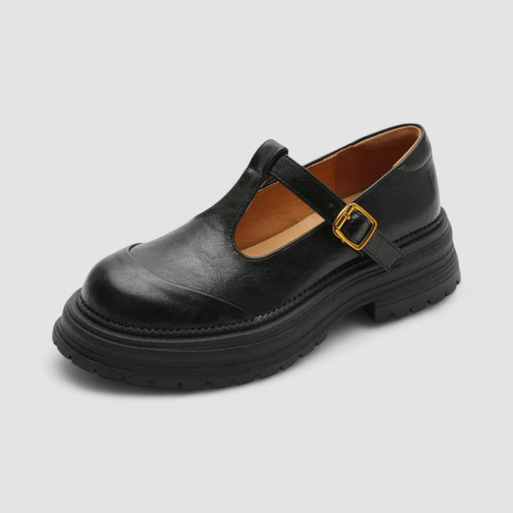 A woman wearing brown T-strap Mary Jane shoes, comfortable on a day around town.