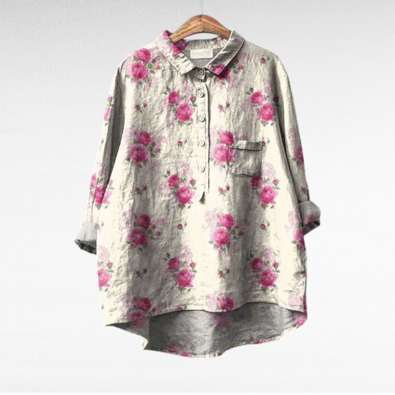 Woman wearing a flowing summer blouse with an elegant all-over print.