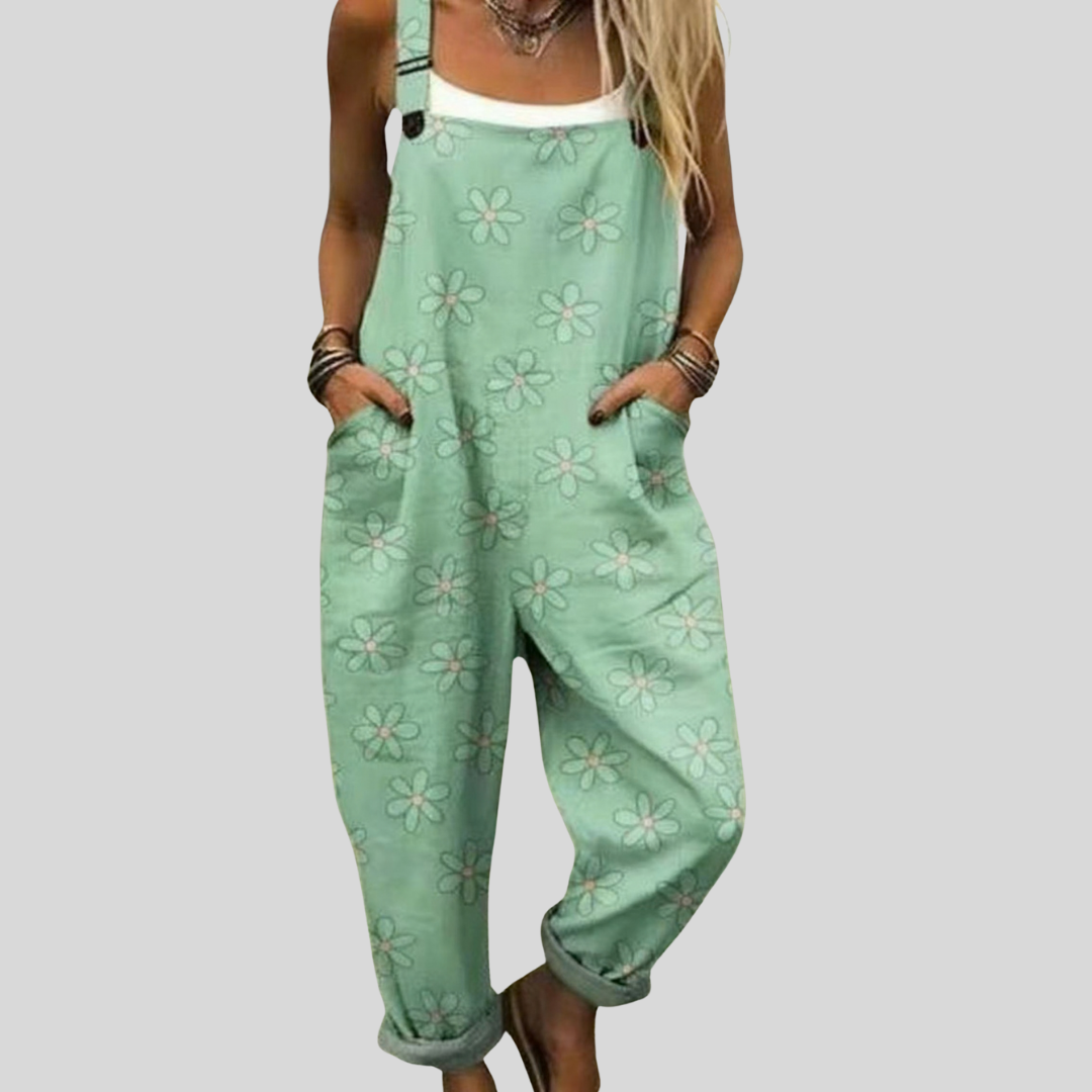 Women's relaxed-fit dungarees in soft mint green with a scattered white floral print, wide-leg style.
