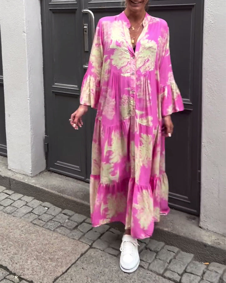 Woman wearing the Abigail flowing maxi dress with a delicate print and V-neckline, the skirt moving softly as she walks.