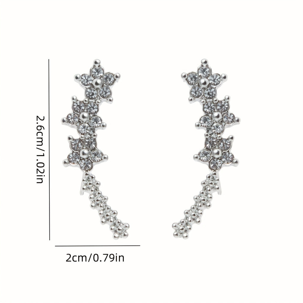 Rose gold floral crawler earrings with delicate sparkling floral motif following the curve of the ear