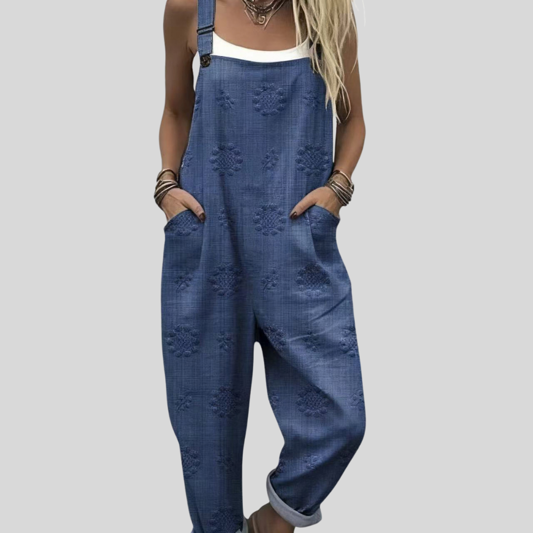 Woman wearing the Sinéad™ mid-blue harem-leg dungarees with a subtle tone-on-tone woven snowflake motif across the fabric.