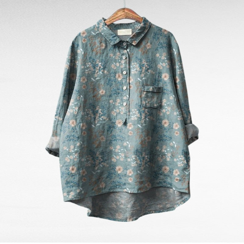 Woman wearing a flowing summer blouse with an elegant all-over print.