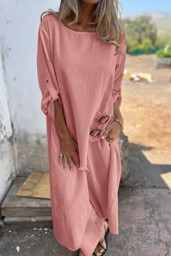 A woman wearing a flowing draped two-piece set with an asymmetric hem, relaxed and elegant.