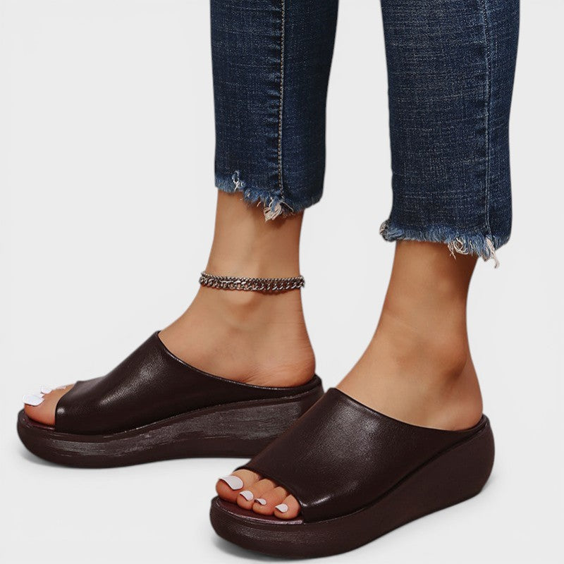 Open wedge mule sandals in white and brown with wide straps and a balanced wedge sole