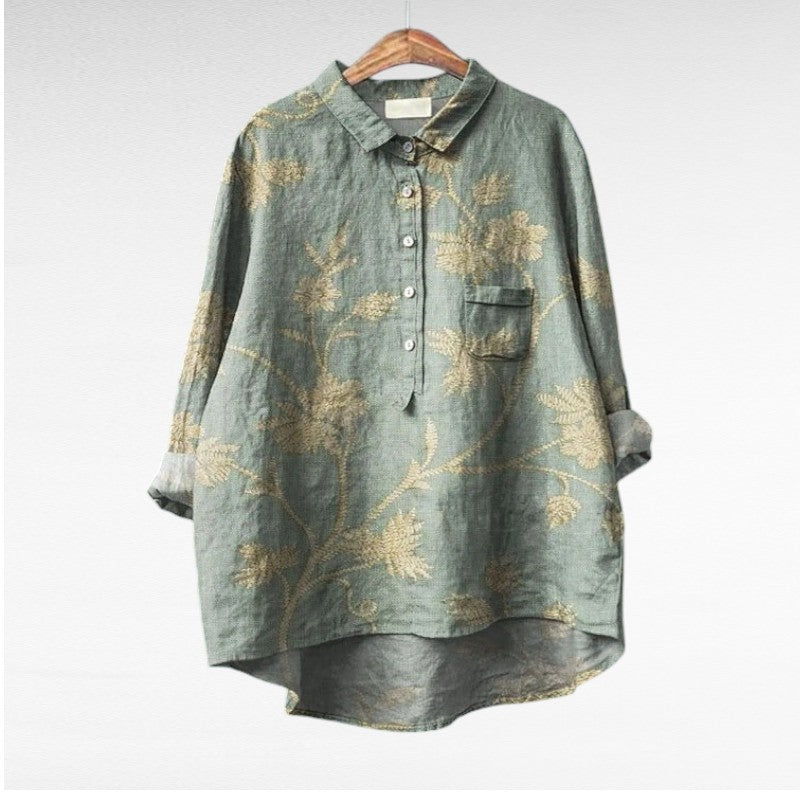 Woman wearing a flowing summer blouse with an elegant all-over print.