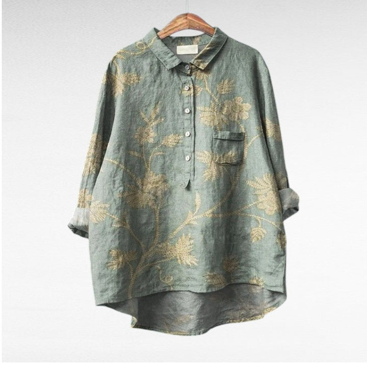 Woman wearing a flowing summer blouse with an elegant all-over print.