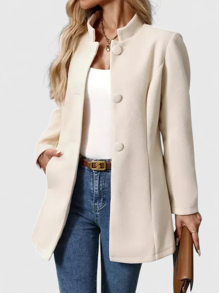 A woman wearing a collarless tailored jacket with a button front