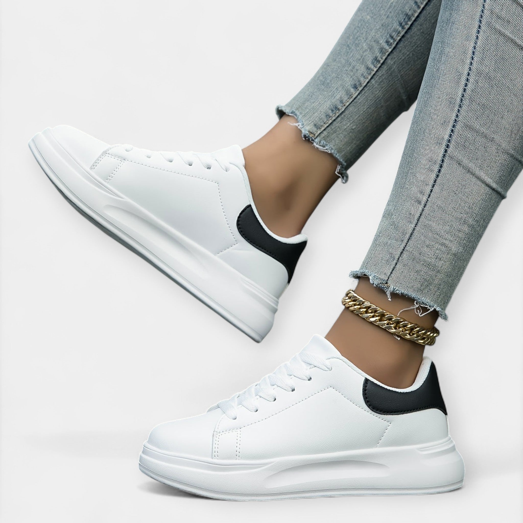 Women's classic white trainers with a clean minimal design and cushioned support sole