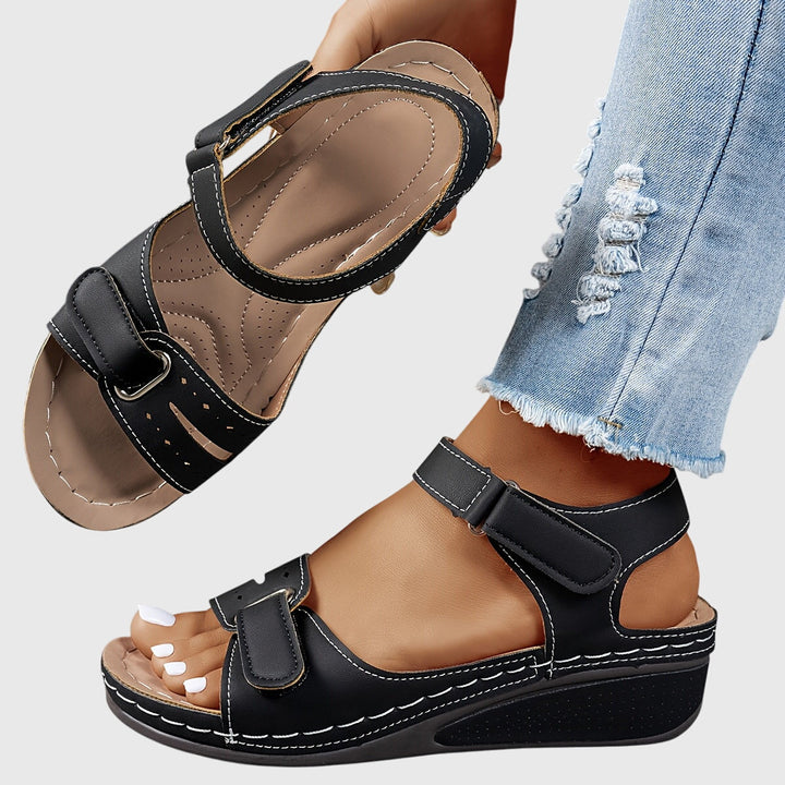 A woman wearing wide-fit supportive sandals with a relaxed summer outfit, walking with ease and confidence.