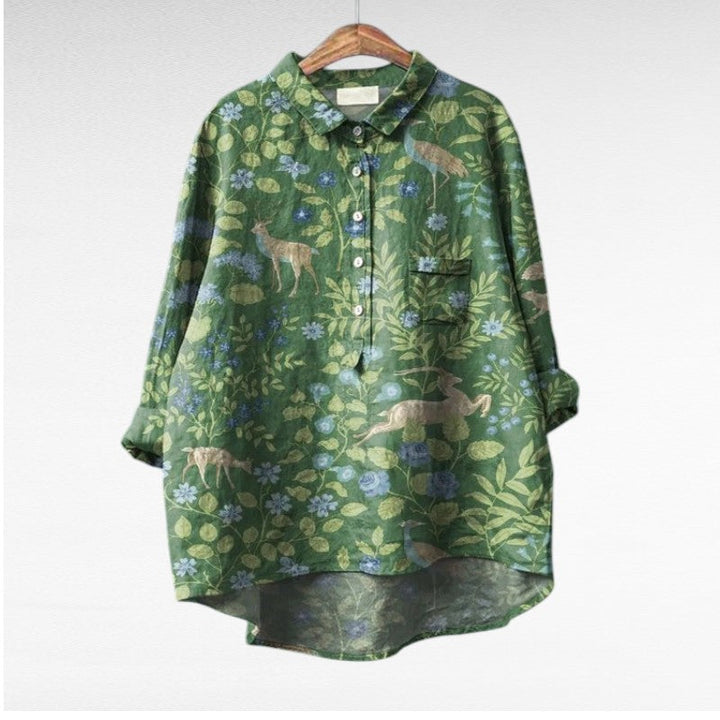 Woman wearing a flowing summer blouse with an elegant all-over print.