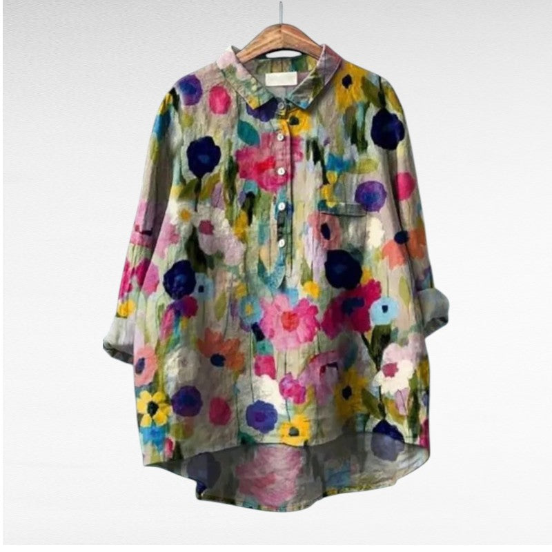 Woman wearing a flowing summer blouse with an elegant all-over print.