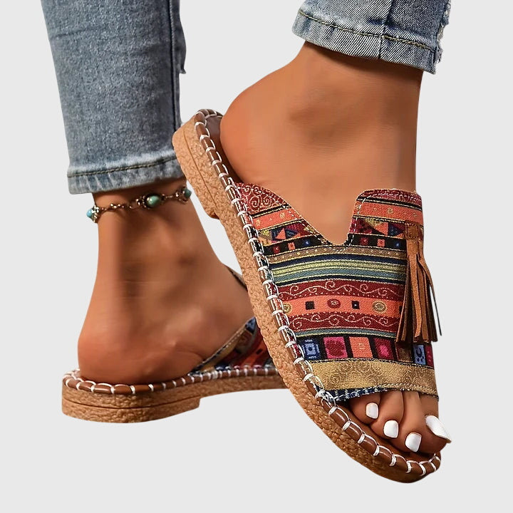 Flat boho sandals with colourful printed upper and swinging fringe detail