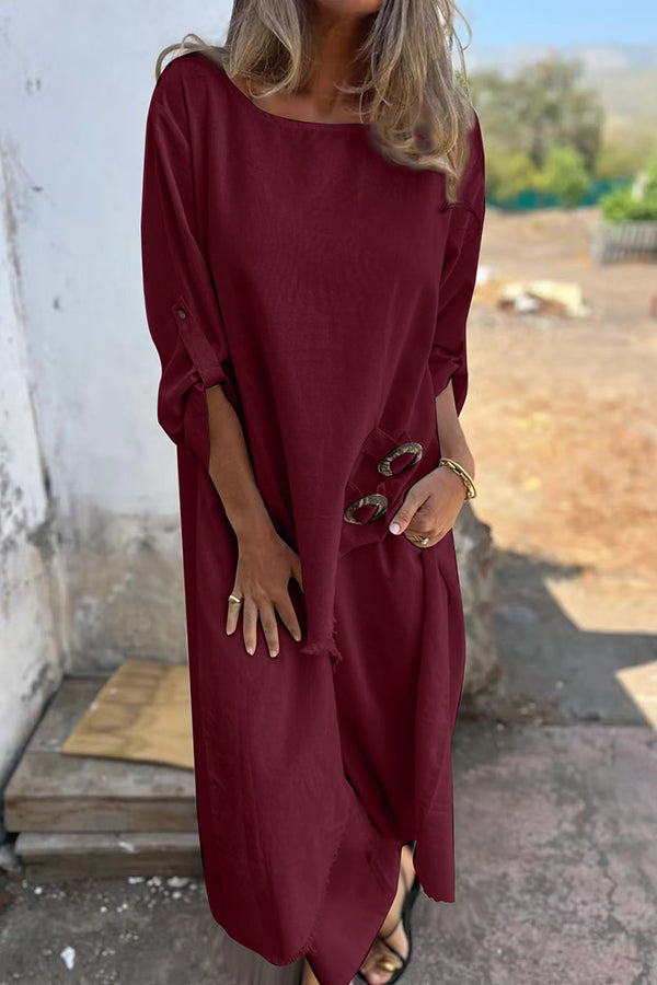 A woman wearing a flowing draped two-piece set with an asymmetric hem, relaxed and elegant.
