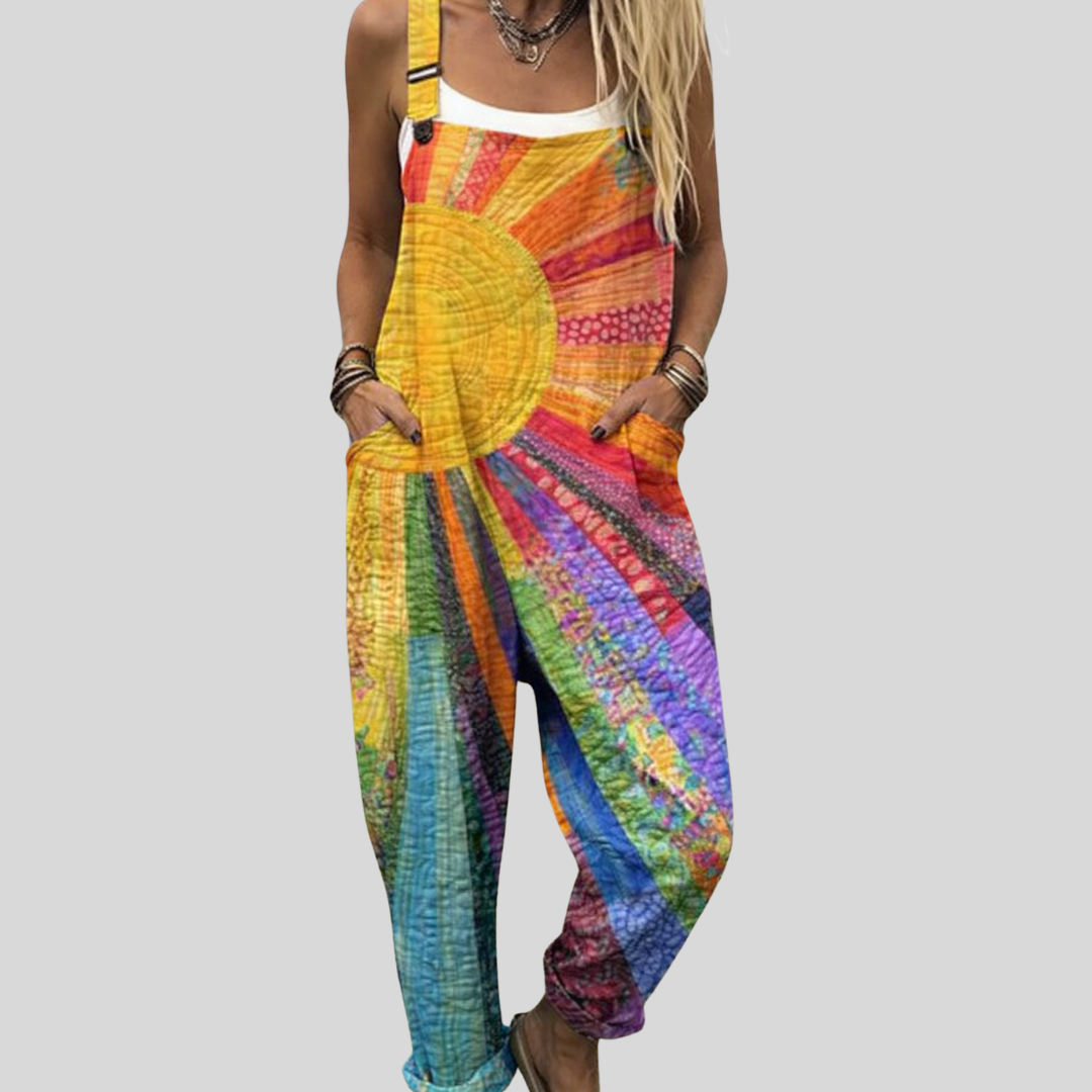 Multicolour batik dungarees featuring a bold sun design in yellow, orange, pink and blue.