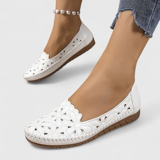 A woman wearing soft open-woven casual sandals on a warm, sunny day.