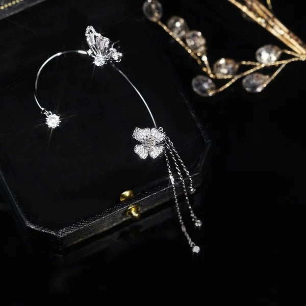 Gold celestial arc earring with a butterfly detail, framing the ear with sparkling luminosity