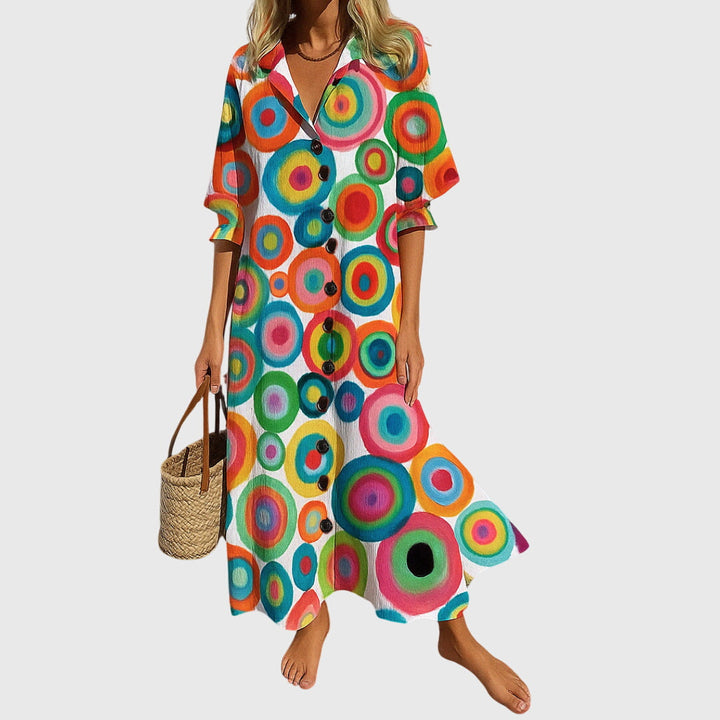 Woman wearing a romantic bohemian maxi dress with delicate patterns and a softly draped silhouette.