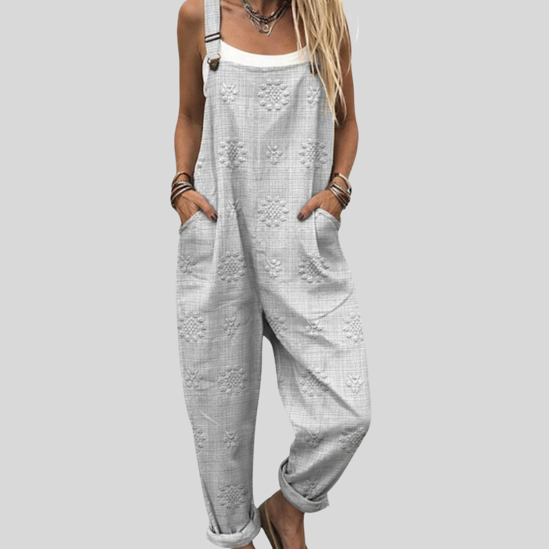 Grey wide-leg dungarees with a delicate tone-on-tone floral pattern, adjustable straps and side pockets.