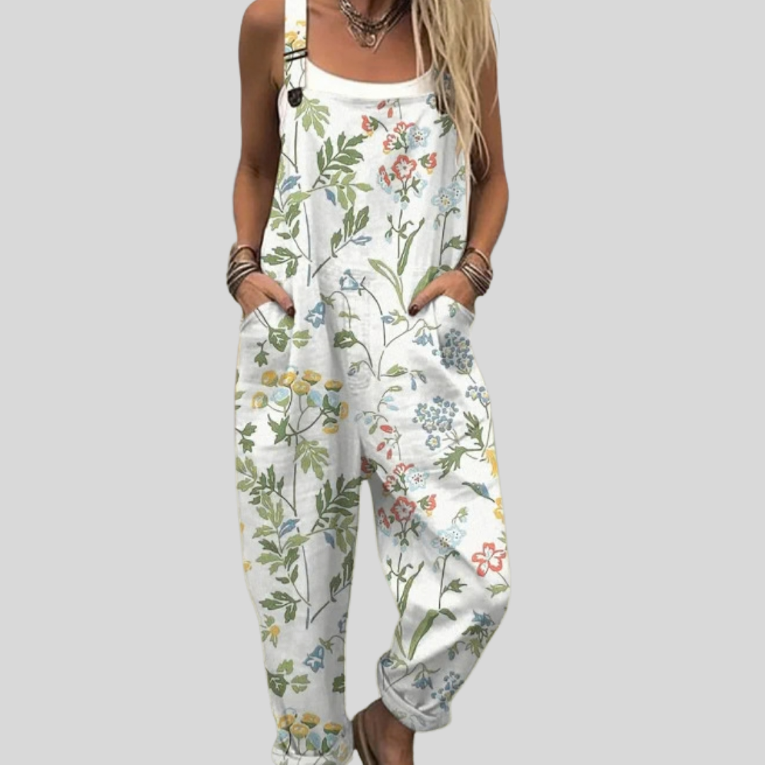 White wide-leg dungarees with soft wildflower and meadow-grass print in gentle tones, from Mary Cork Ireland.