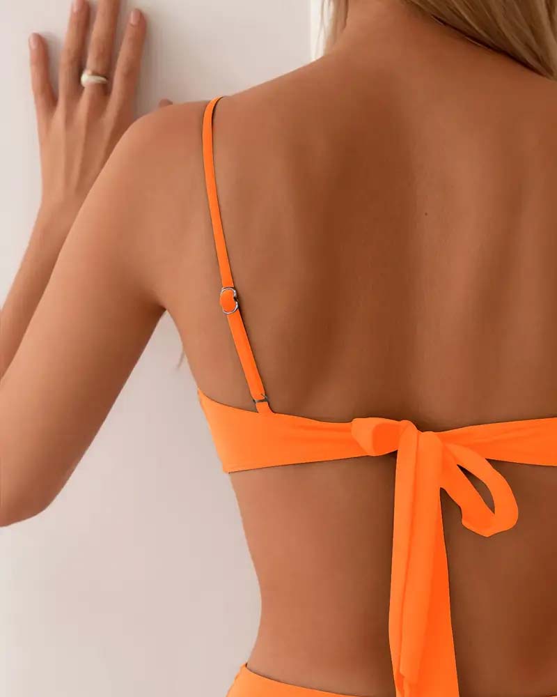 Navy blue bandeau bikini with a gold ring detail and colour-block panels