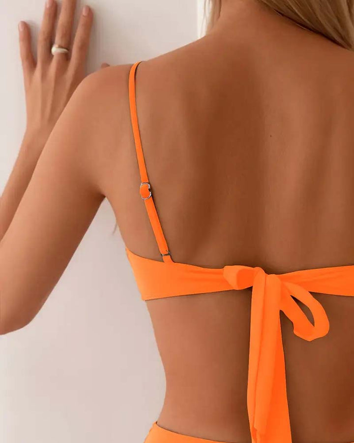 Navy blue bandeau bikini with a gold ring detail and colour-block panels