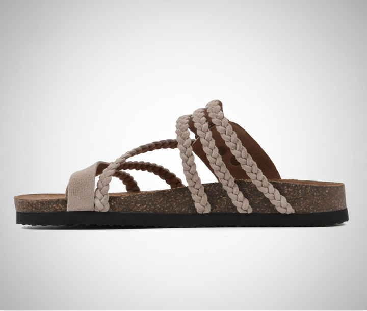Natural woven flat sandal with an adjustable buckle strap and cushioned footbed