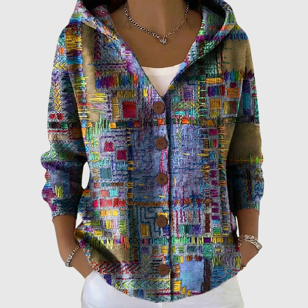 A woman wearing a soft hooded button cardigan open over a top on a mild spring day.
