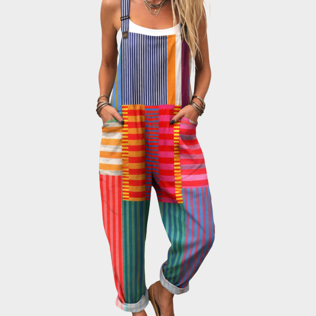 Woman wearing bright multicolour striped dungarees with adjustable straps, lively and full of character.