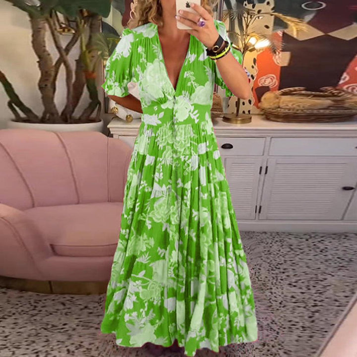 A woman wearing the Josephine bold floral maxi dress with a flowing full-length skirt at a garden gathering.
