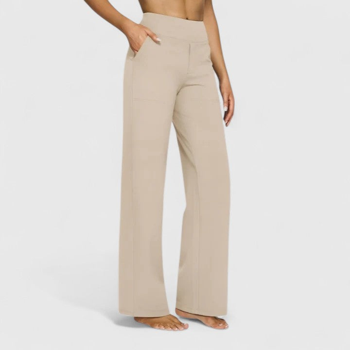 Woman wearing pull-on trousers with a soft blouse, relaxed and comfortable at home.