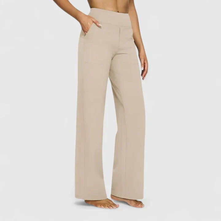 A woman in tailored trousers styled with a simple top for an elegant, comfortable everyday look.