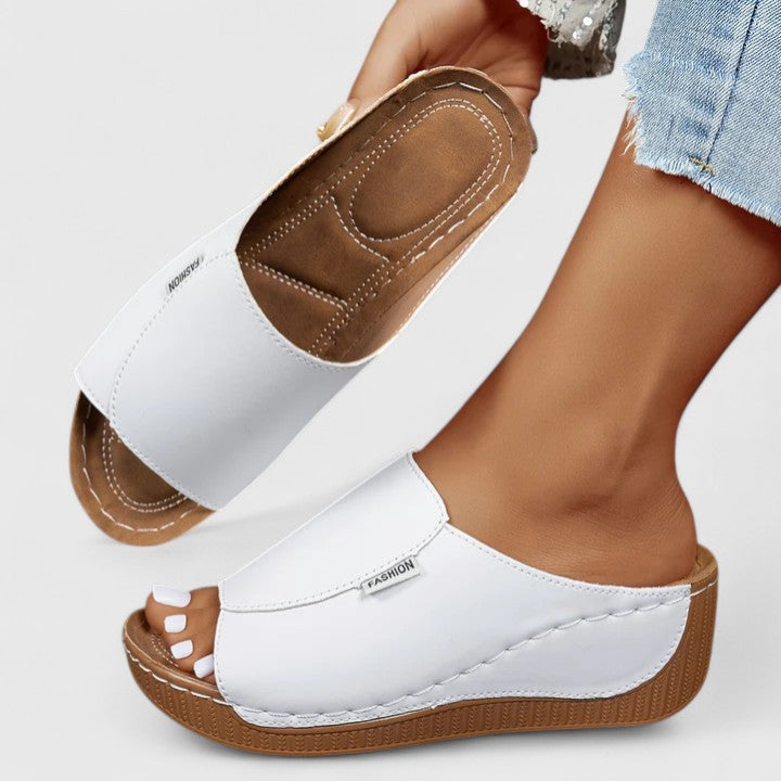 A woman in tan lightweight sandals stepping out gracefully, feet cushioned and supported.