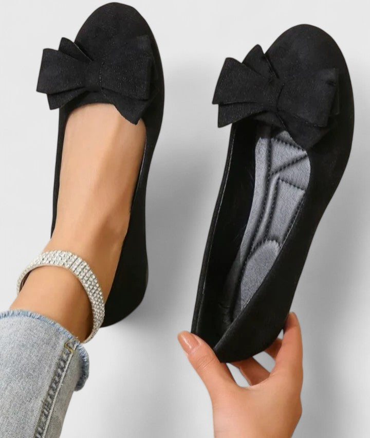 A woman walking easily in dark green classic comfort sandals with a broad, cushioned footbed.