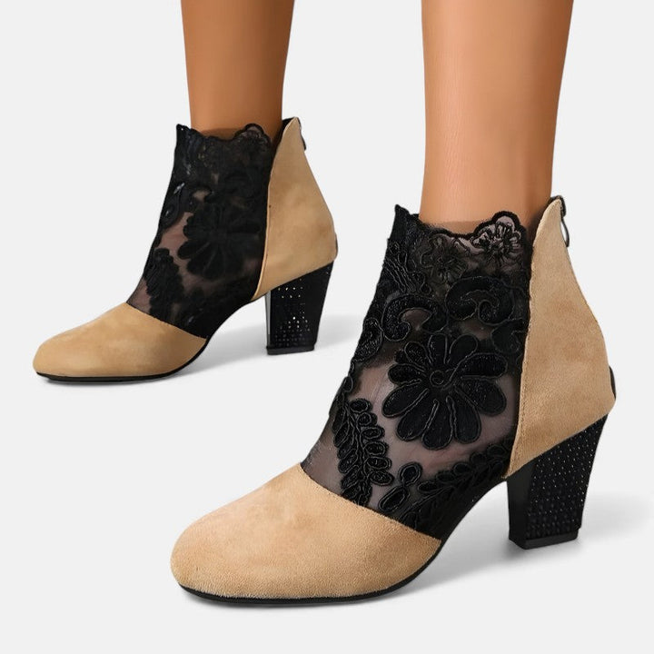 A woman wearing wide-toe orthopaedic heels, standing comfortably in an elegant everyday look.