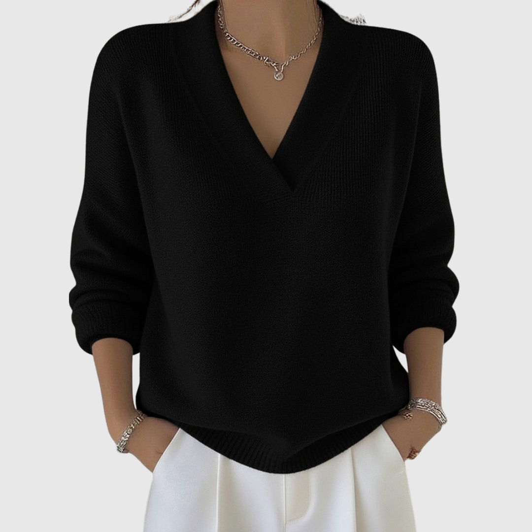 A woman wearing a soft draped V-neck jumper with jeans for an effortlessly elegant look.