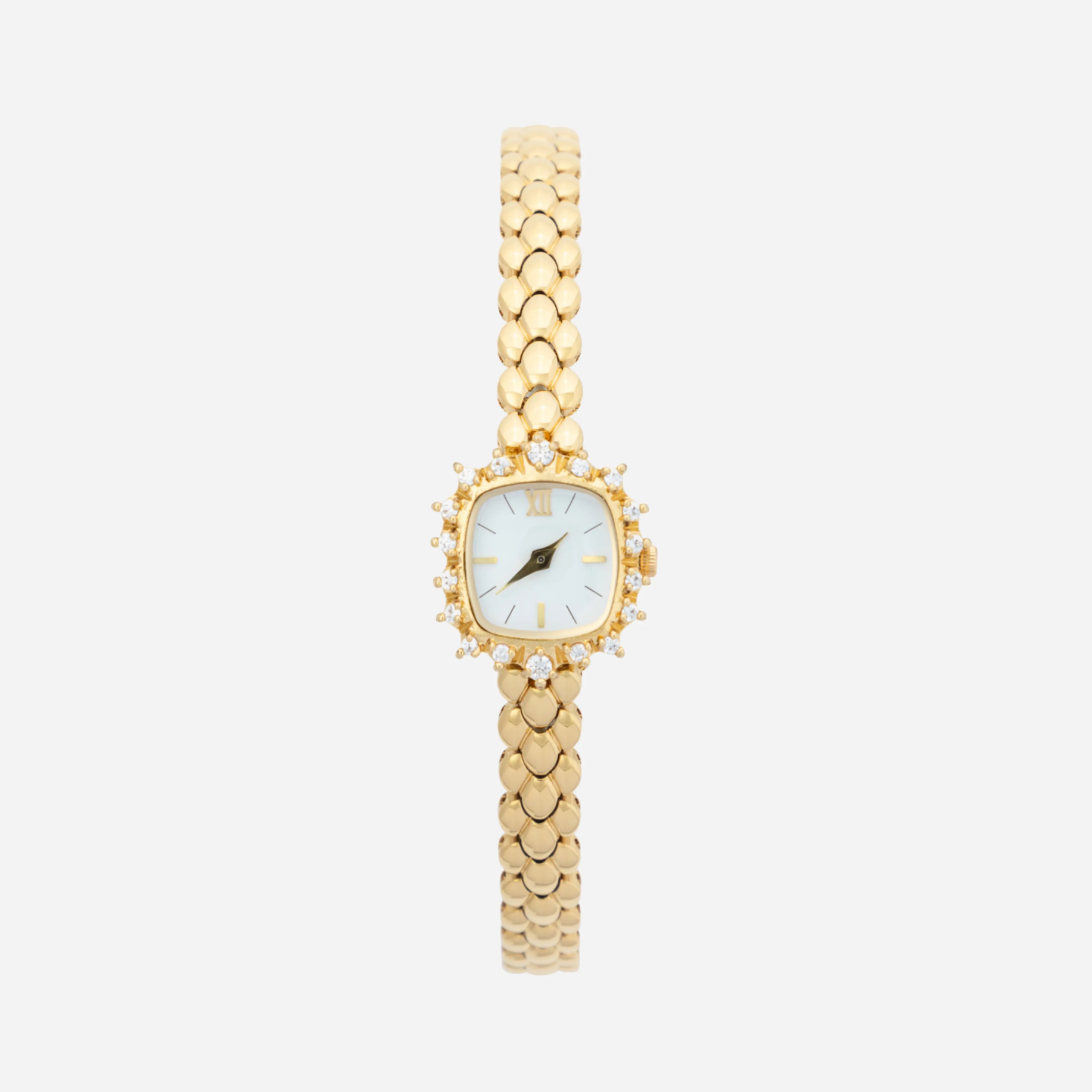 Slim women's bracelet watch with a vibrant colour detail against a simple light dial