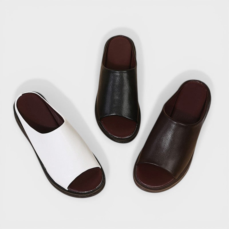Open wedge mule sandals in white and brown with wide straps and a balanced wedge sole
