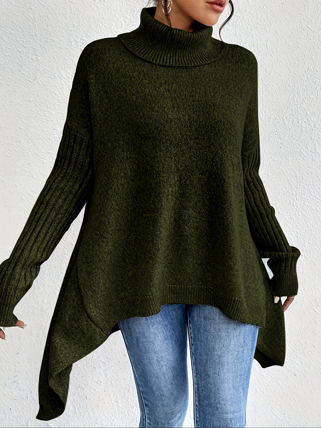 A woman wearing a stand-collar jumper with a chic asymmetric drape, warm and polished.