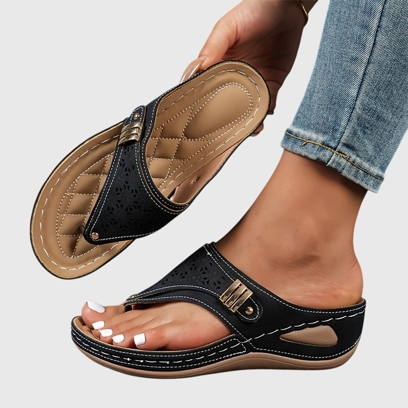 A woman in grey comfort flip-flops relaxing outdoors, feet cushioned and supported.