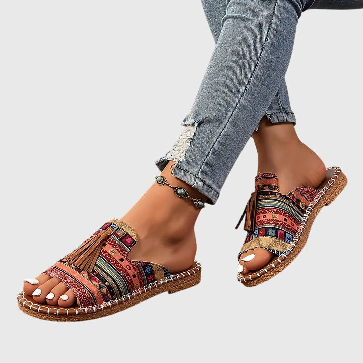 Flat boho sandals with colourful printed upper and swinging fringe detail