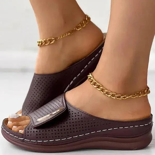 Open-work wedge sandals in bordeaux with a small metallic ornament on the upper