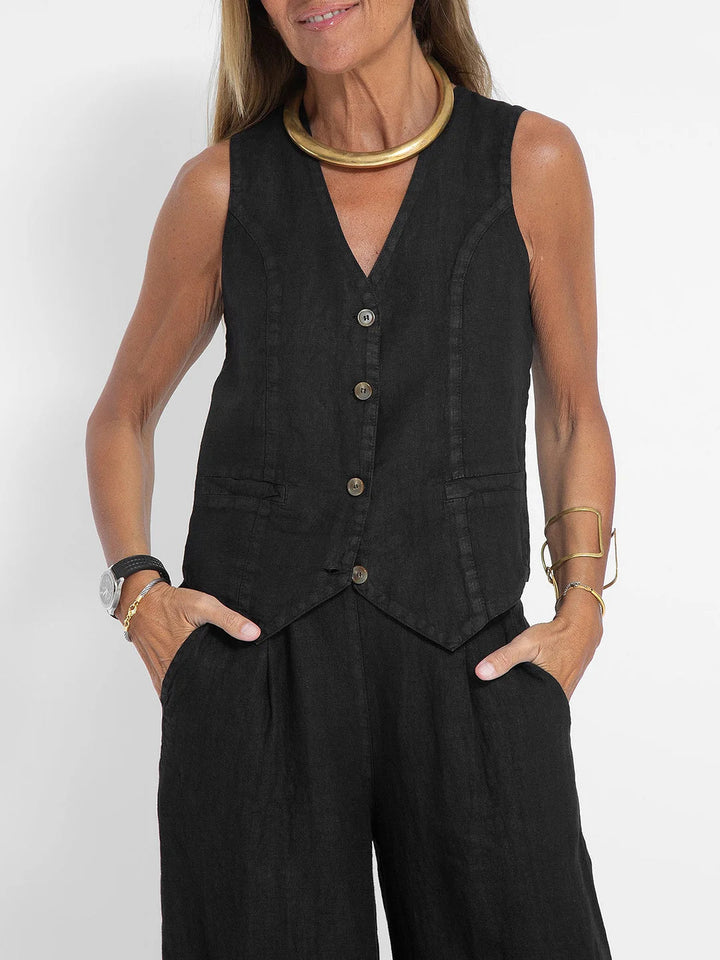A woman wearing a tailored waistcoat with flowing wide-leg trousers